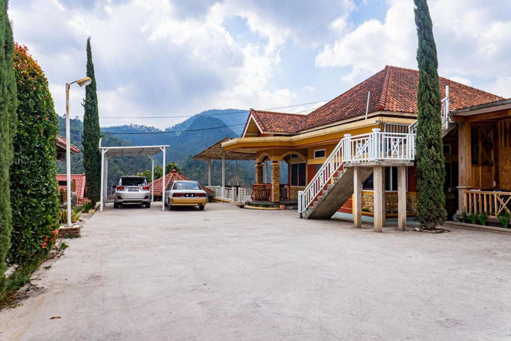 a house with a car parked in front of it at RedDoorz near Kawah Putih Ciwidey in Bandung