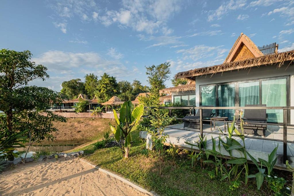 a villa with a view of the house at The Sanctuary Nam Ngum Beach Resort in Vang Vieng
