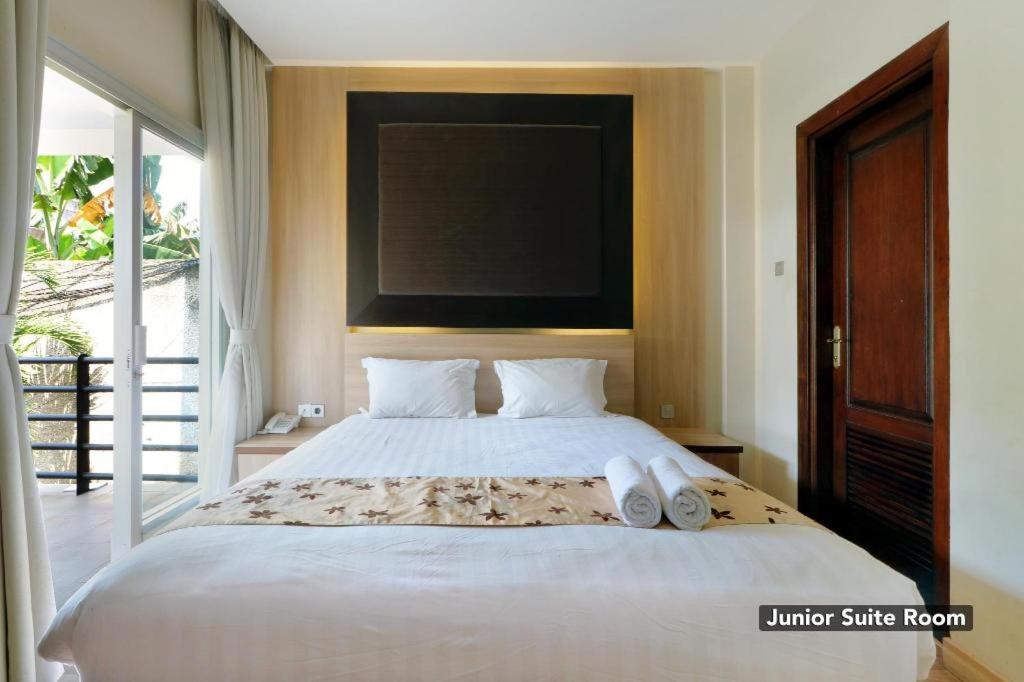 Postel nebo postele na pokoji v ubytování Mutiara Suites
