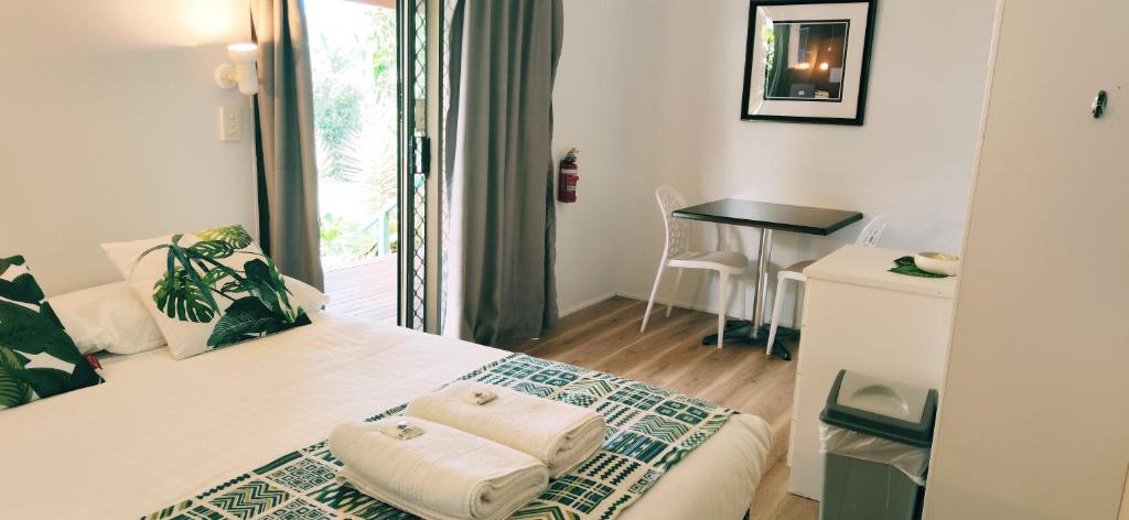um quarto de hotel com uma cama com uma mesa e uma janela em Lilyponds Holiday Park em Mapleton