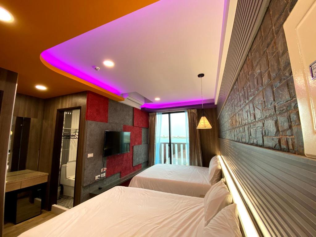 Postel nebo postele na pokoji v ubytování 奧斯卡海景民宿Oscar Boutique Seaview Homestay