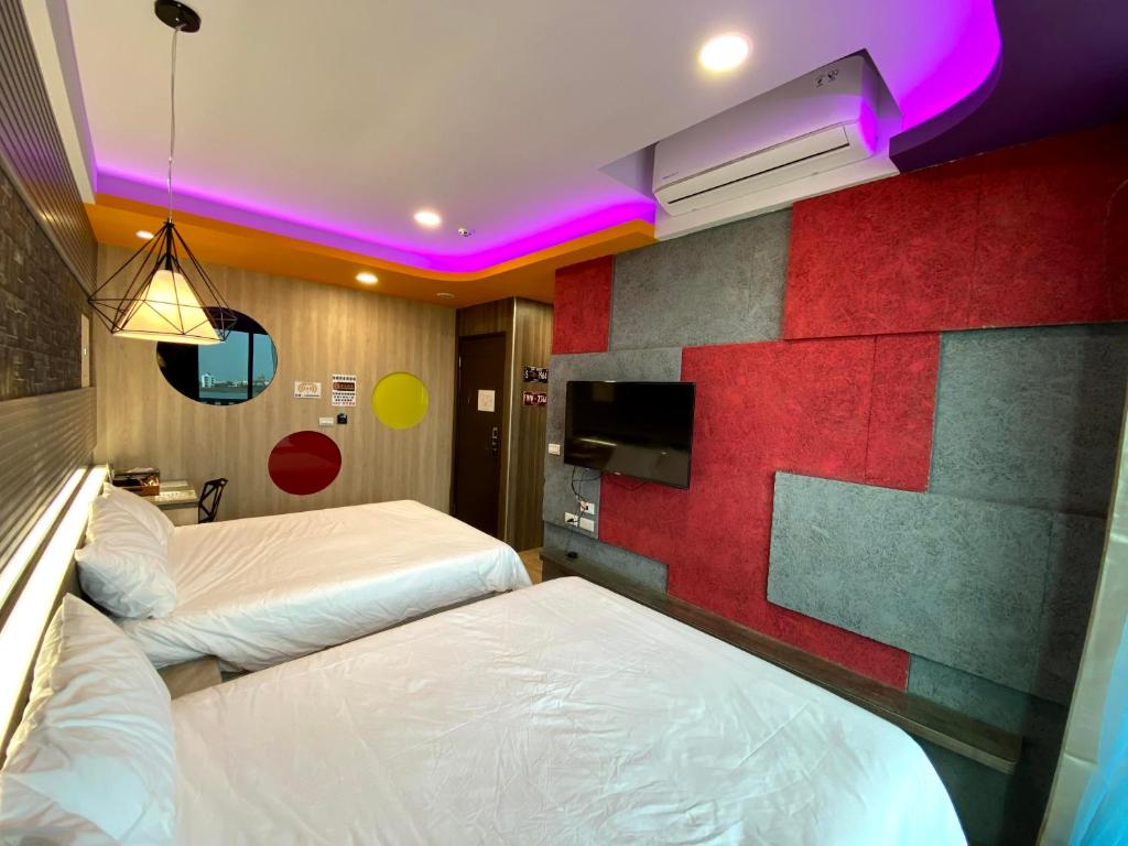 Postel nebo postele na pokoji v ubytování 奧斯卡海景民宿Oscar Boutique Seaview Homestay