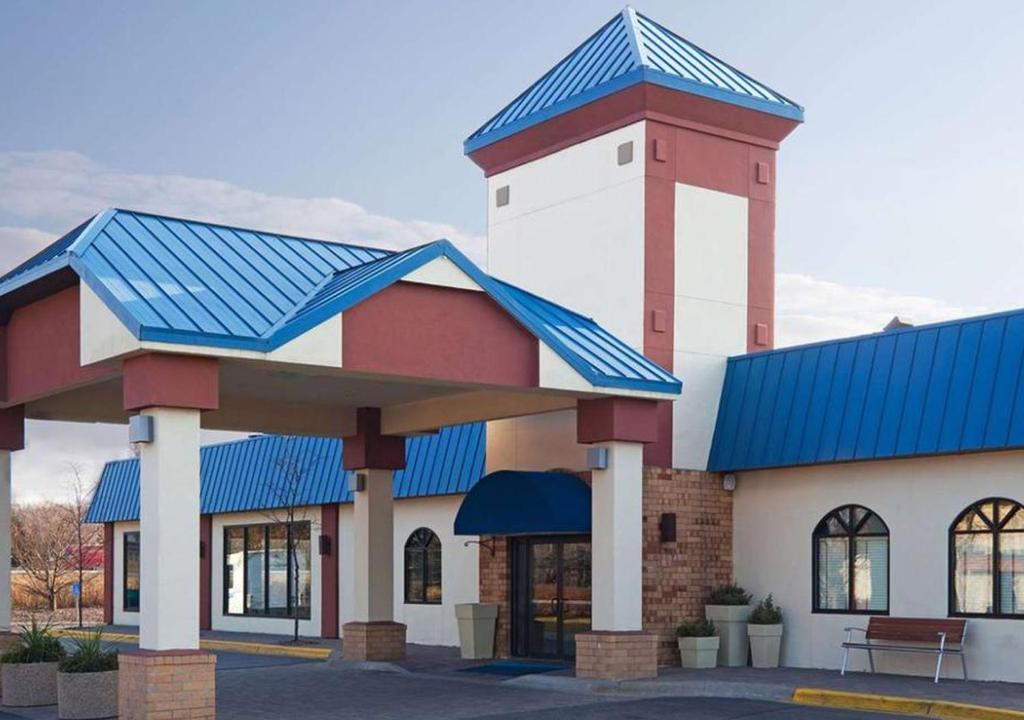 a building with a blue roof at Norwood Inn & Suites Eagan St Paul & Mall of America in Eagan