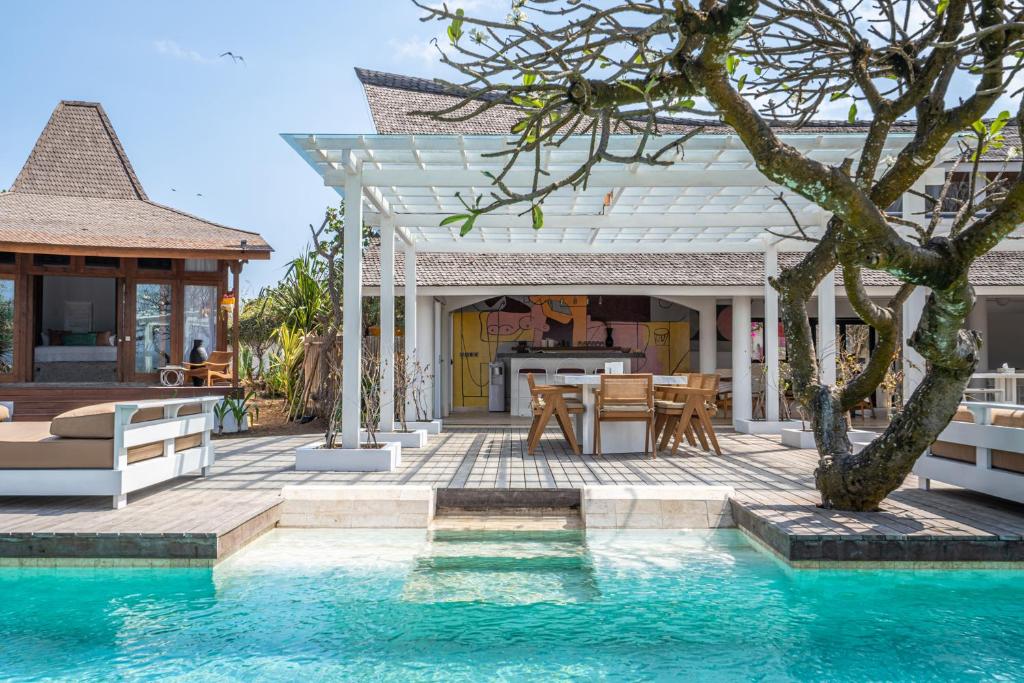 a villa with a swimming pool and a house at Mandala The Bay in Nusa Lembongan