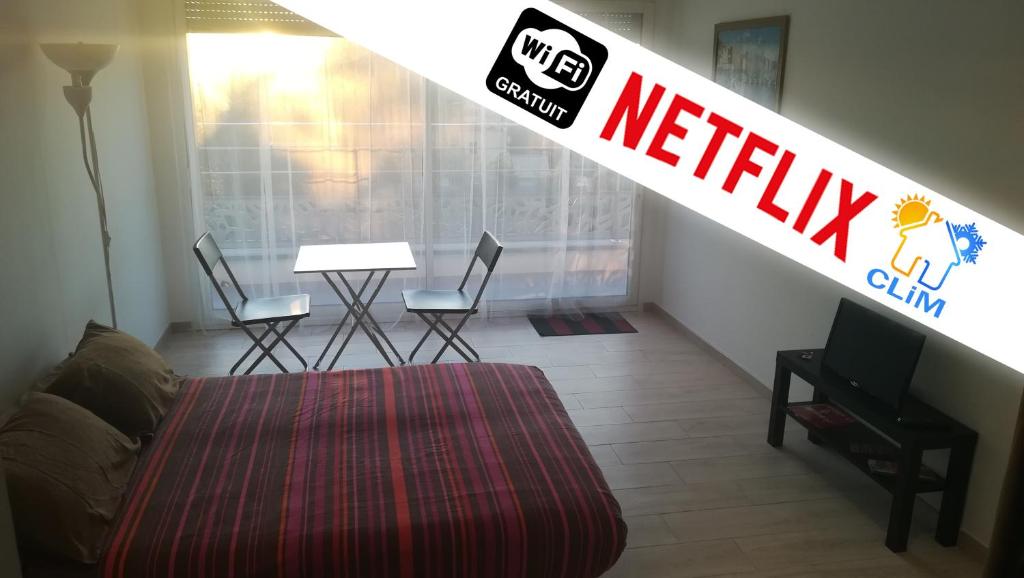 a bedroom with a netflix sign on a stairway at Le Studio des 3 Moulins in Sigean