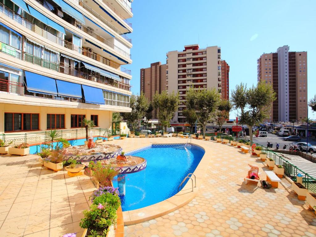 a pool in the middle of a city with buildings at Apartment Coblanca III in Benidorm