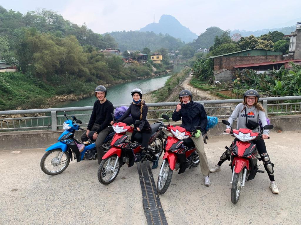 a group of people riding motorcycles on a bridge at Be's Home & Tours in Ha Giang