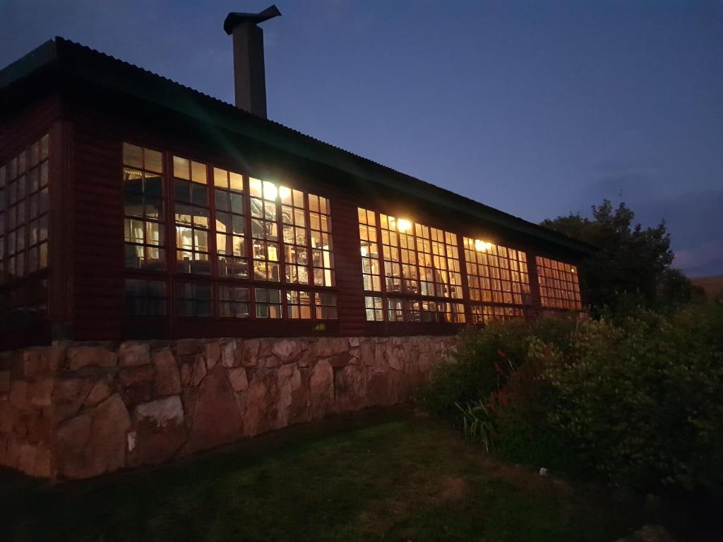 a large building with lit up windows at night at Moonlight Meadows just outside Dullstoom in Dullstroom