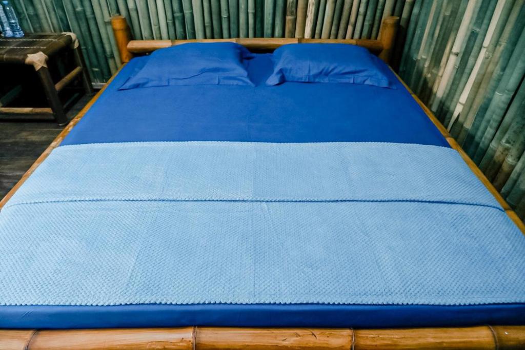 Postel nebo postele na pokoji v ubytování Backpacker Kawah Ijen