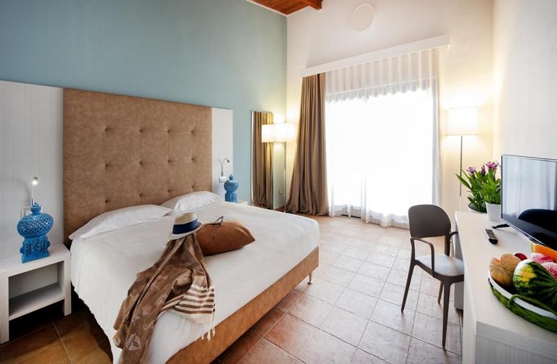 Postel nebo postele na pokoji v ubytování Eco Resort Dei Siriti