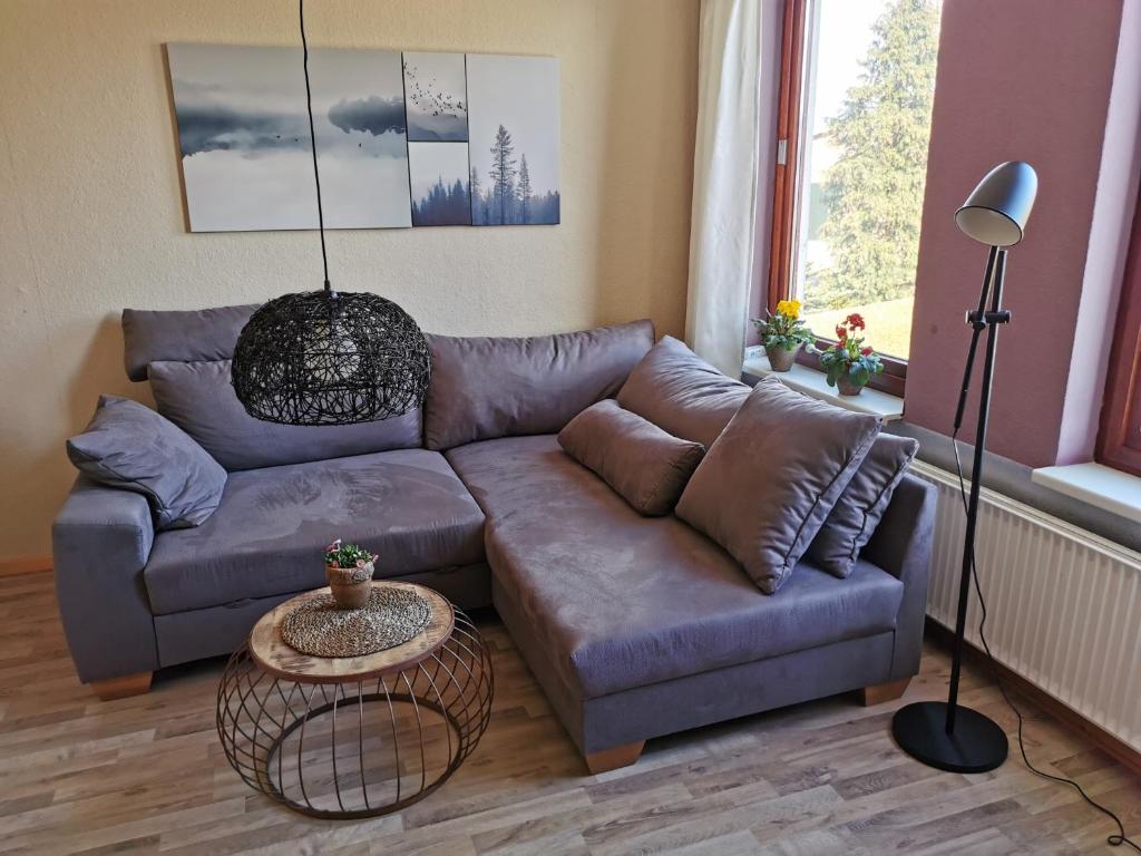 a living room with a couch and a table at Ferienwohnung Ostsee in Karby