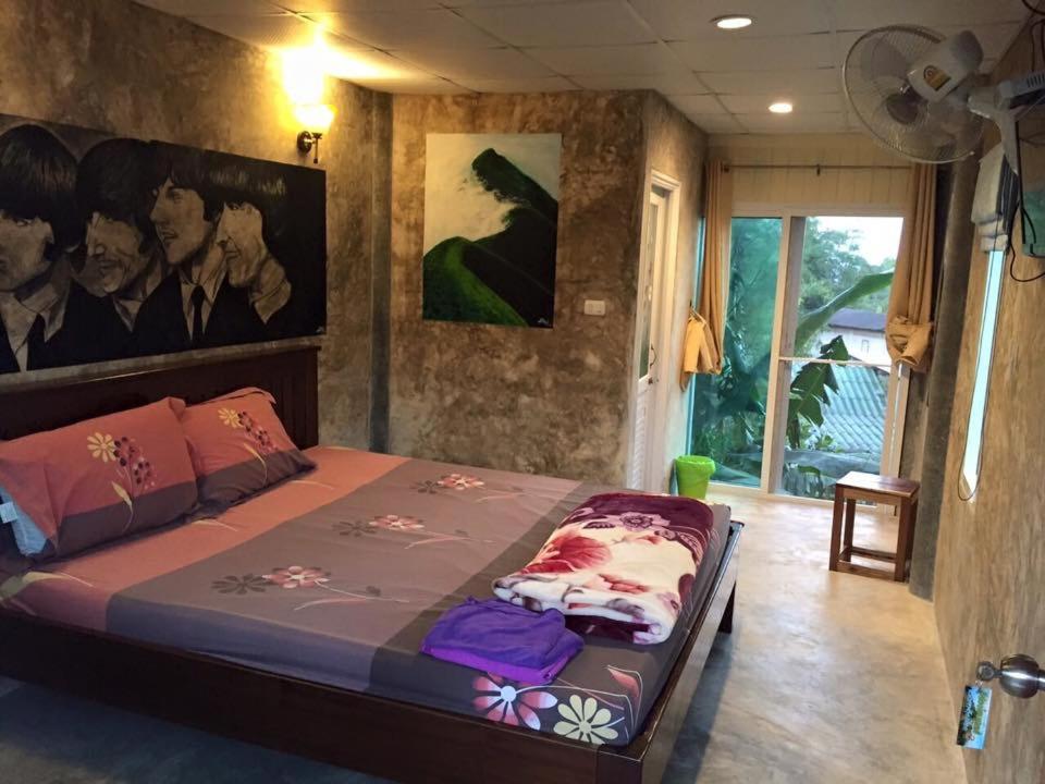 ein Schlafzimmer mit einem großen Bett in einem Zimmer in der Unterkunft อีต่องโฮมสเตย์ in Thong Pha Phum