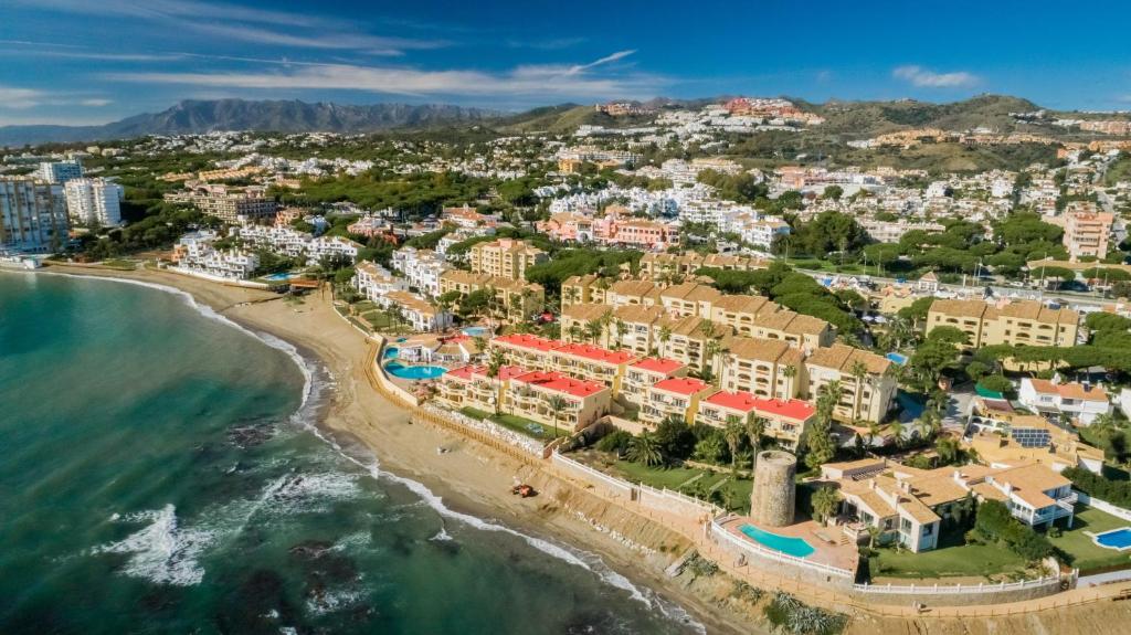 an aerial view of a resort on the beach at Macdonald Doña Lola Resort in La Cala de Mijas