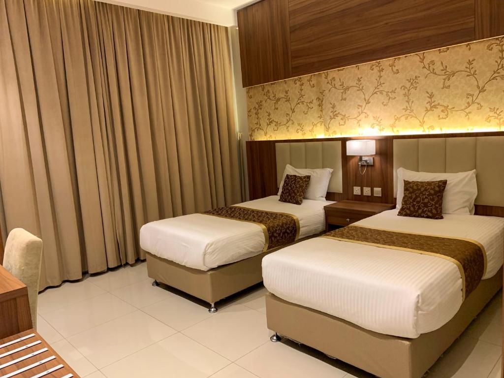 Postel nebo postele na pokoji v ubytování Kayan Al Taif Hotel