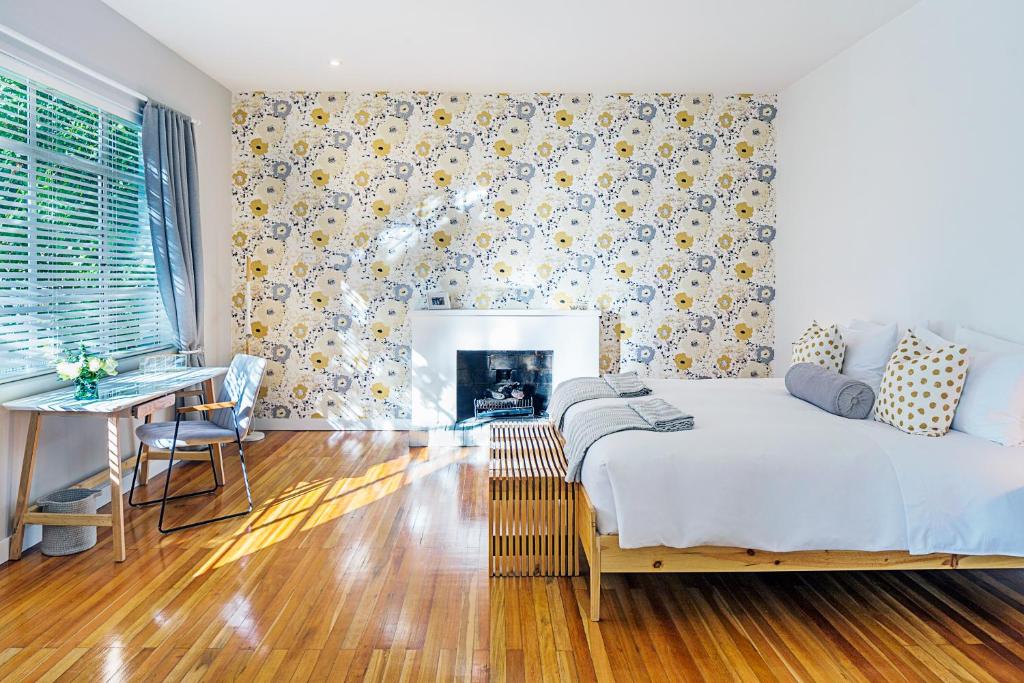 a bedroom with a bed and a table and a fireplace at Casa Legado in Bogotá