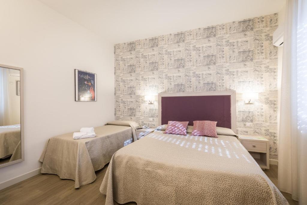 Postel nebo postele na pokoji v ubytování Hotel Pardini