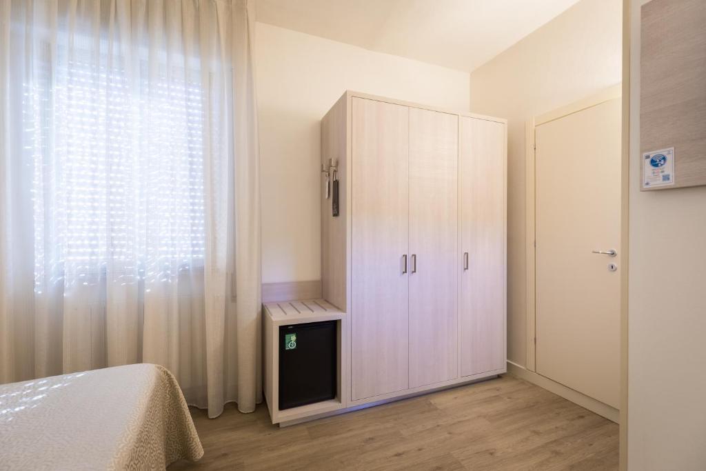 Postel nebo postele na pokoji v ubytování Hotel Pardini