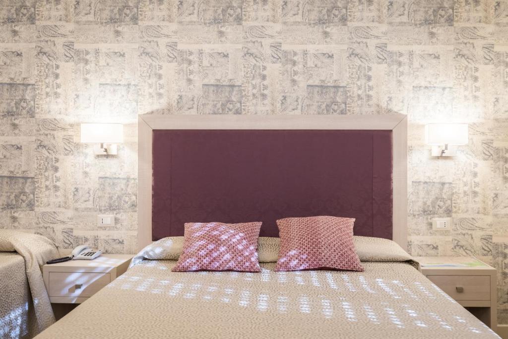 Postel nebo postele na pokoji v ubytování Hotel Pardini