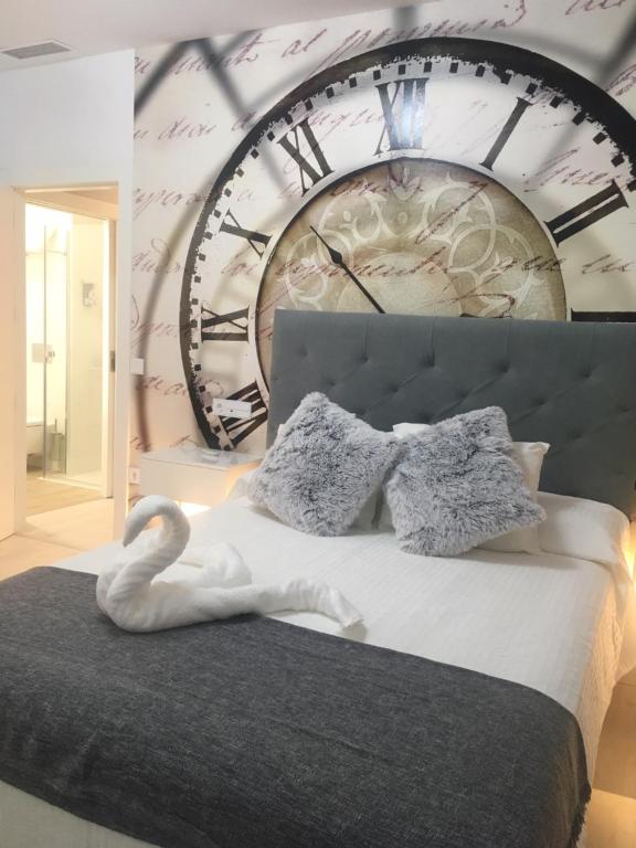 a bedroom with a large clock on the wall at CASA DE TOSCA in Lucena