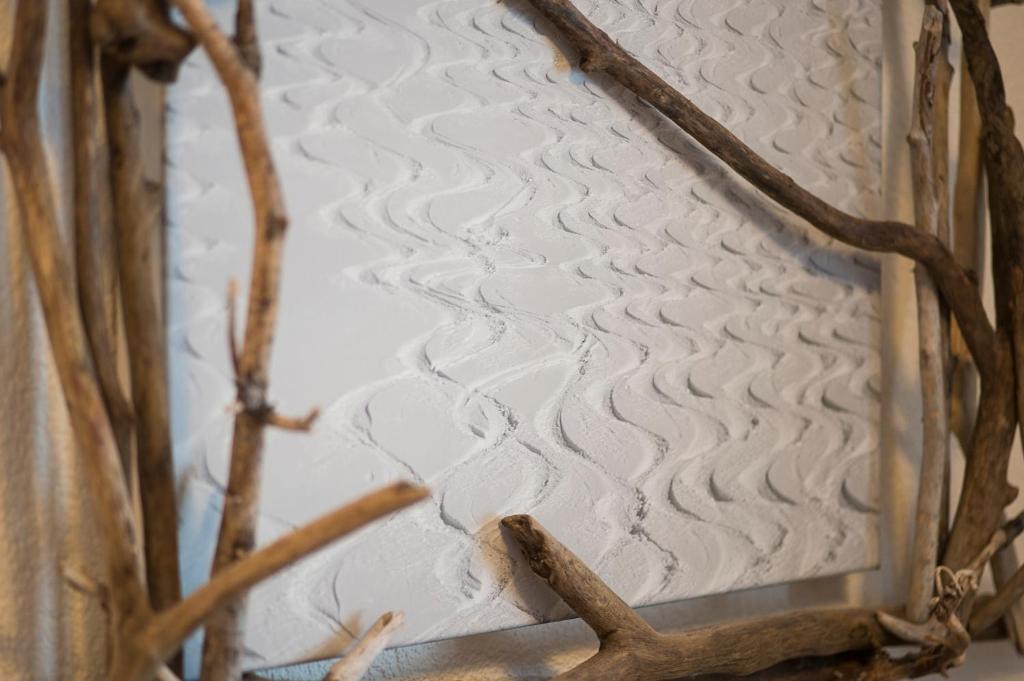 a close up of a bed with branches on it at Fürmesli Appartements in Lech am Arlberg