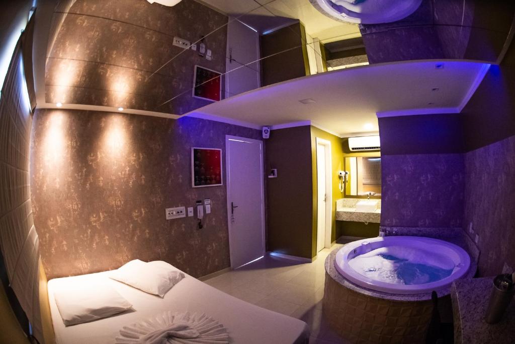 W łazience znajduje się fioletowa toaleta i umywalka. w obiekcie Motel Paradiso Carazinho (Adults Only) w mieście Caràzinho