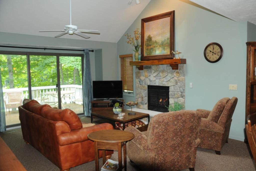 a living room with a couch and a fireplace at Mountainside 612 in Thompsonville