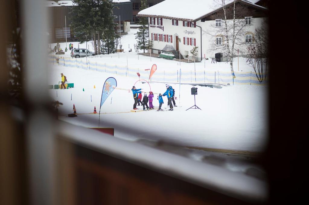 a group of people on skis in the snow at Fürmesli Appartements in Lech am Arlberg