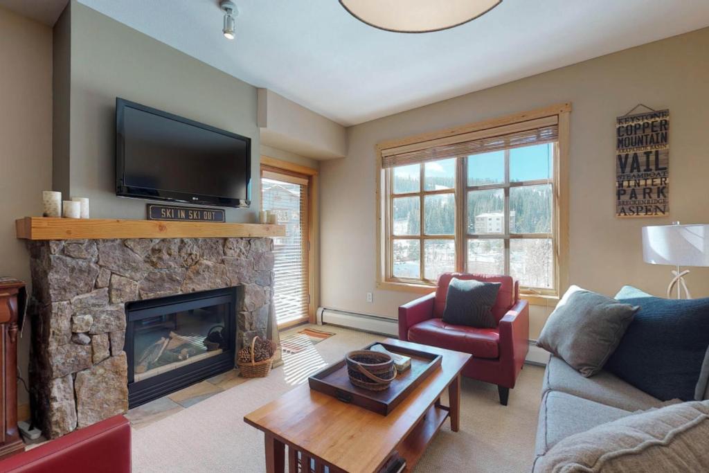a living room with a fireplace and a tv at Copper Mountain Ski Hideaway in Copper Mountain