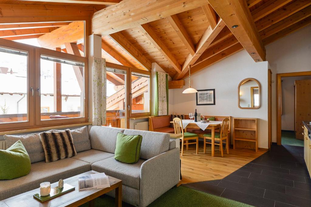 a living room with a couch and a table at Fürmesli Appartements in Lech am Arlberg