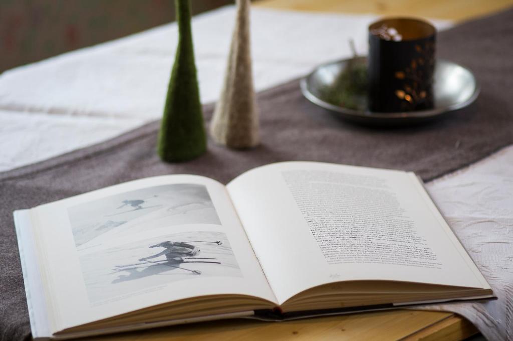 an open book sitting on a table at Fürmesli Appartements in Lech am Arlberg