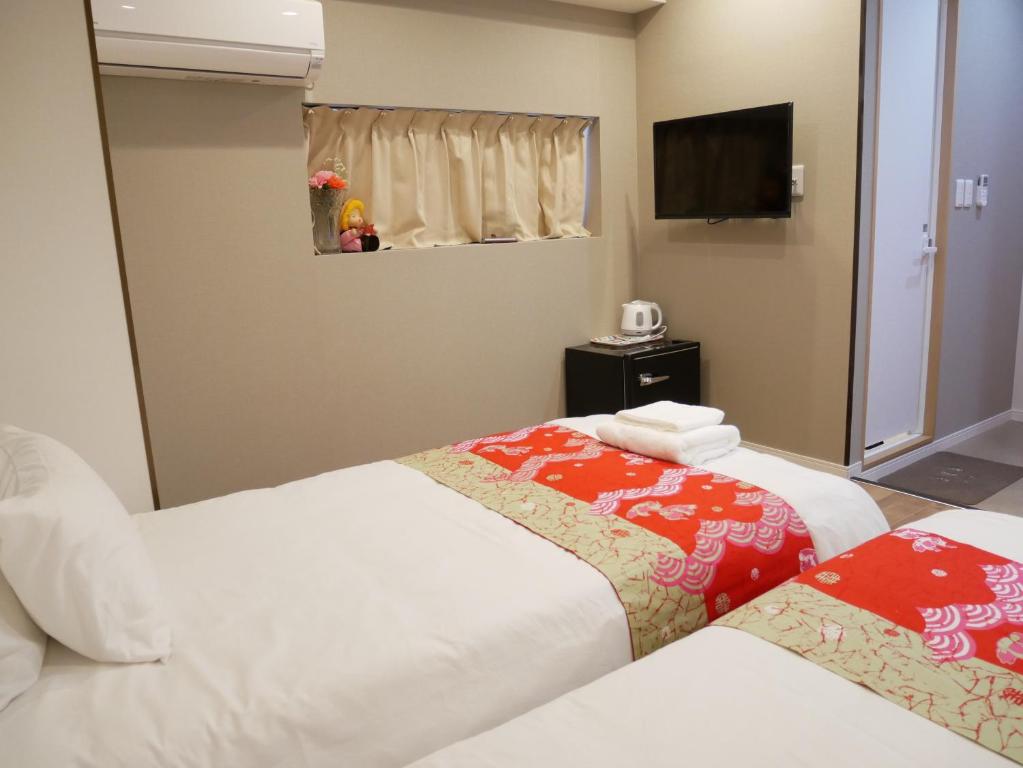 Postel nebo postele na pokoji v ubytování Tokyo shinjukutei Hotel Asahi gruop 東京新宿亭ホテル
