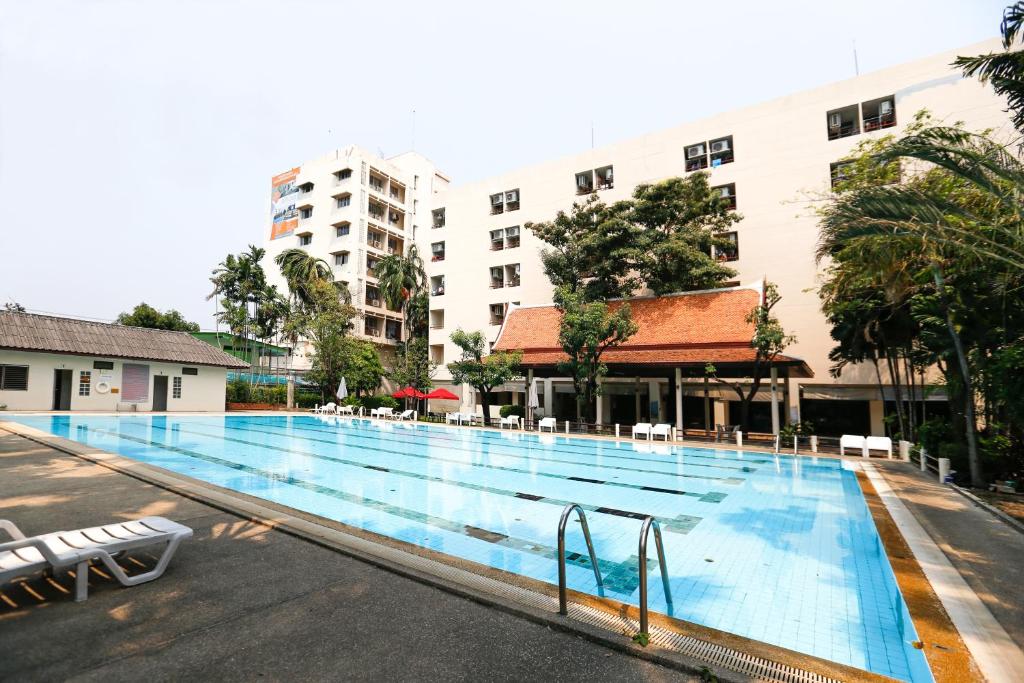 a large swimming pool in front of a building at D-haus Ladprao Residence in Bangkok