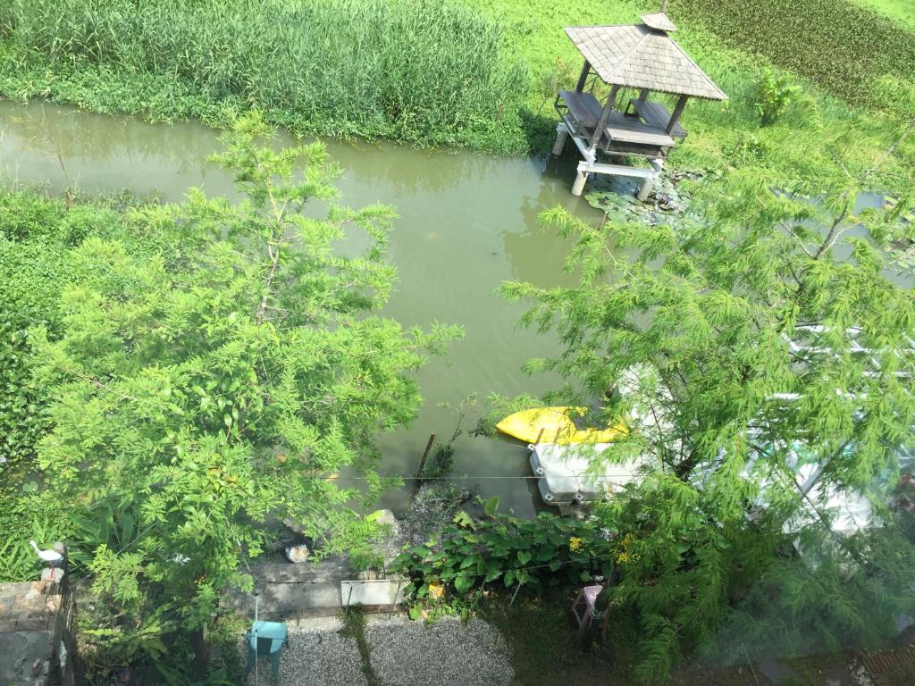 an aerial view of a pond with a boat in it at Beautiful Yilan Resort in Dongshan