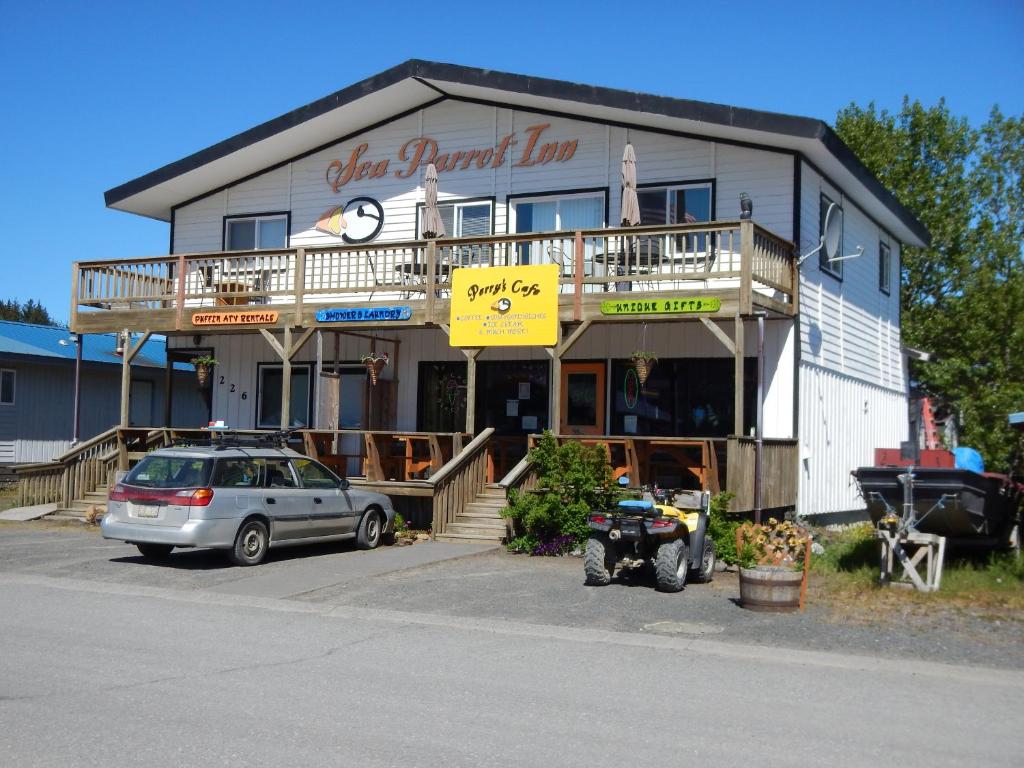 a building with a car parked in front of it at Sea Parrot Inn in Seldovia