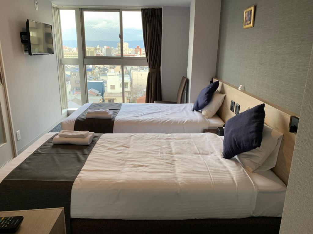 Postel nebo postele na pokoji v ubytování HOTEL STATE TENNOJI