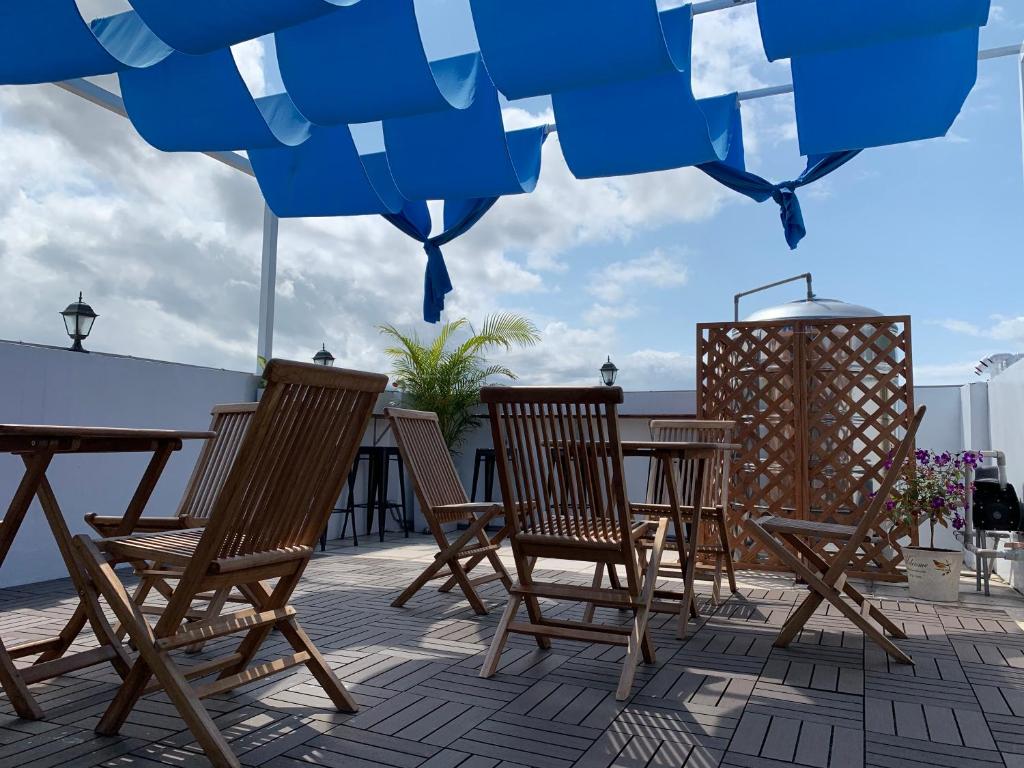 a patio with two chairs and a table on a deck at 910 Hostel (Chengdong) in Yuli