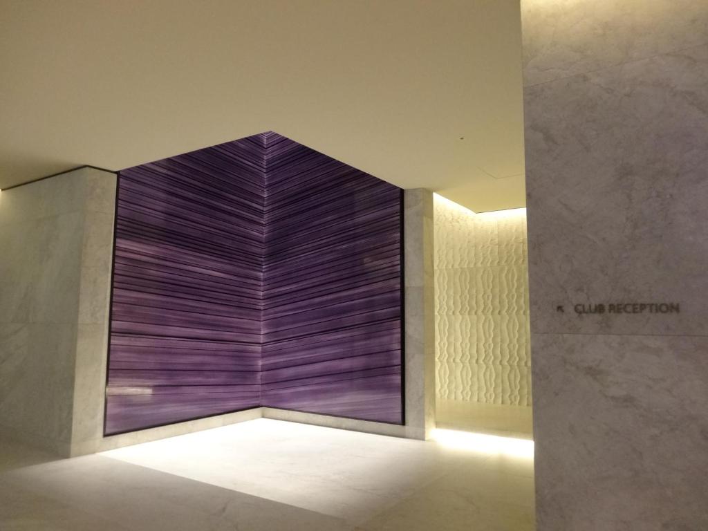 a large purple wall in a room with a light at Four Seasons Hotel Seoul in Seoul