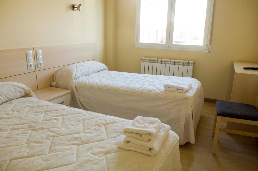 Кровать или кровати в номере Hostal Europa