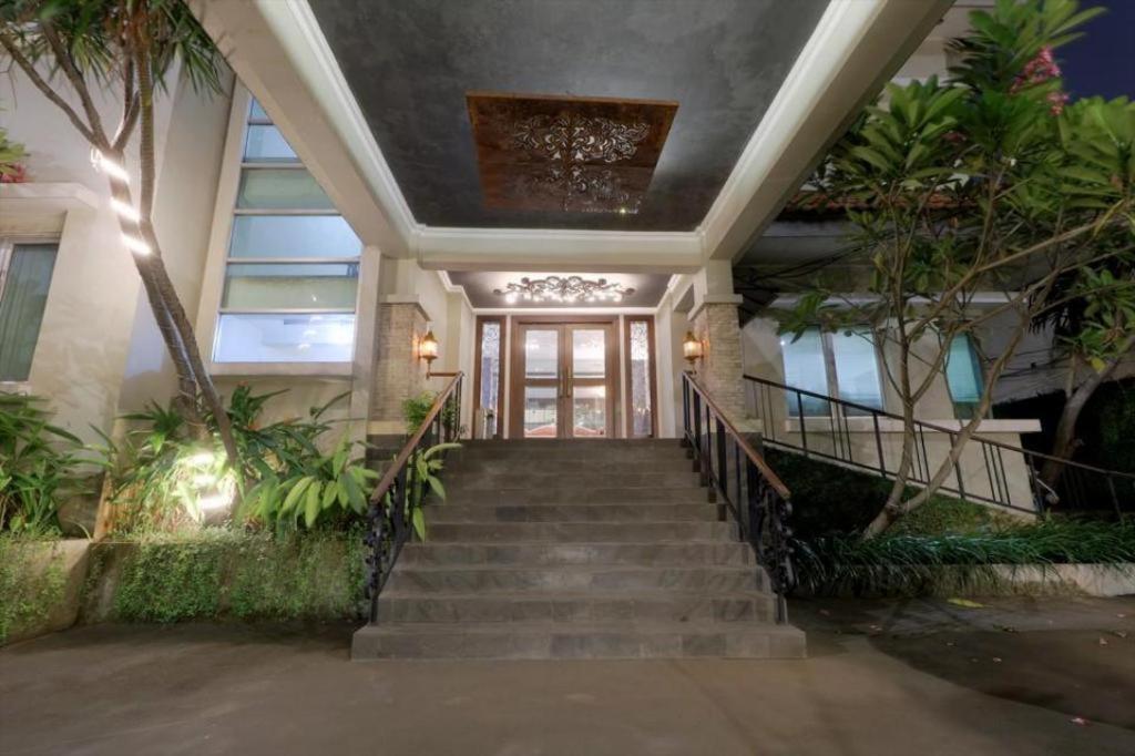 a house with stairs leading to the front door at Mutiara Suites in Jakarta