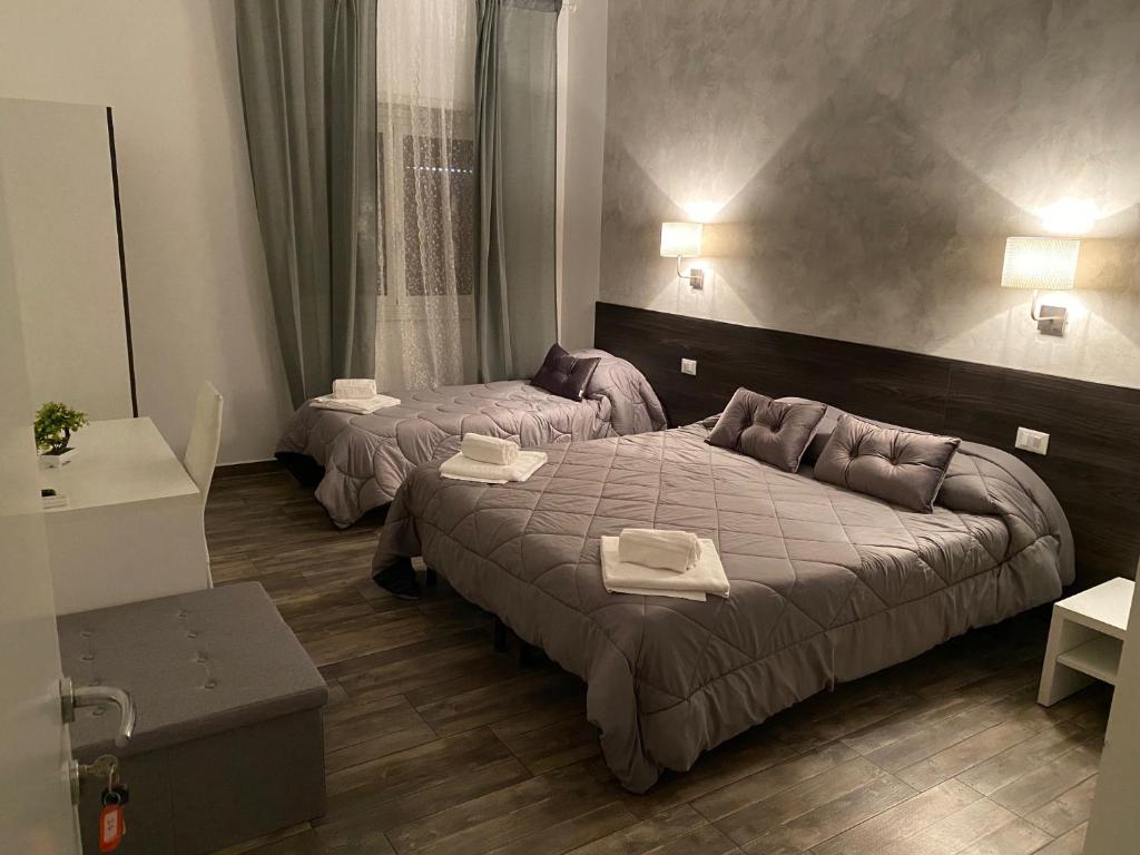 a hotel room with two beds in a room at TIBURTINA INN GUEST HOUSE in Rome