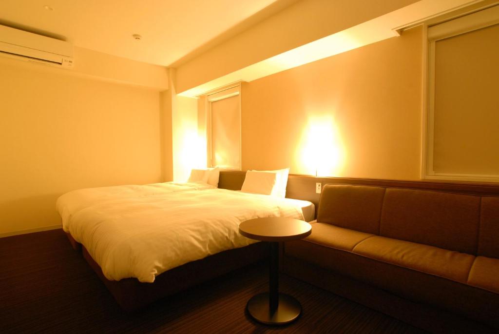Postel nebo postele na pokoji v ubytování AB Hotel Fukaya
