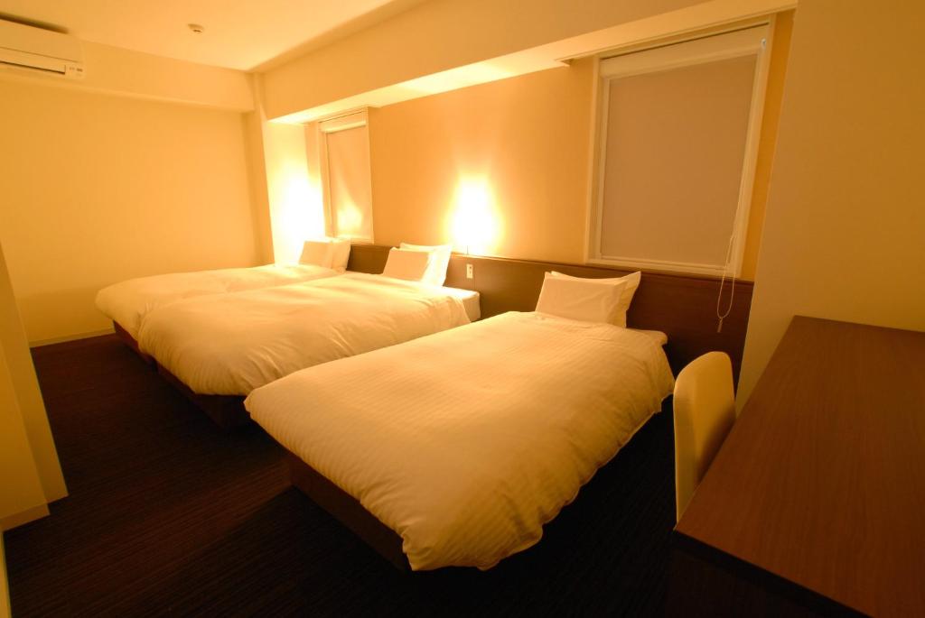 Postel nebo postele na pokoji v ubytování AB Hotel Fukaya