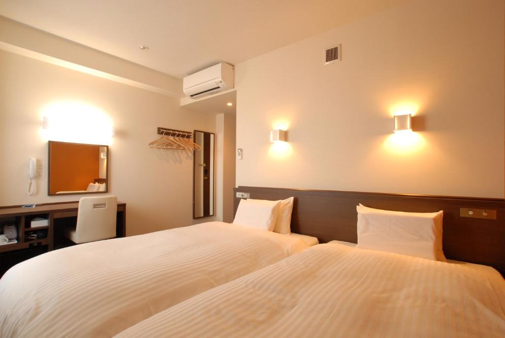 Postel nebo postele na pokoji v ubytování AB Hotel Fukaya