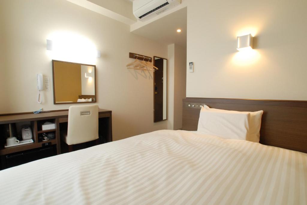 Postel nebo postele na pokoji v ubytování AB Hotel Fukaya