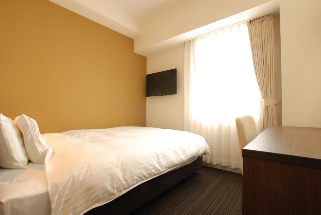Postel nebo postele na pokoji v ubytování AB Hotel Fukaya