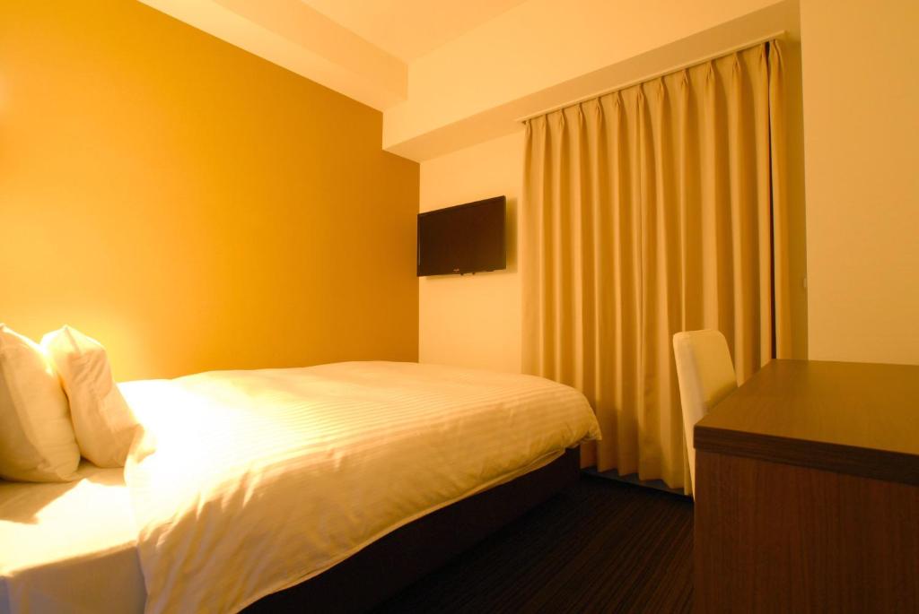 Postel nebo postele na pokoji v ubytování AB Hotel Fukaya
