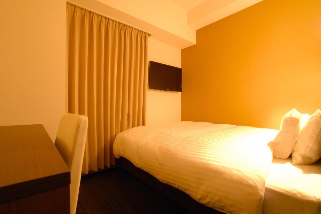 Postel nebo postele na pokoji v ubytování AB Hotel Fukaya
