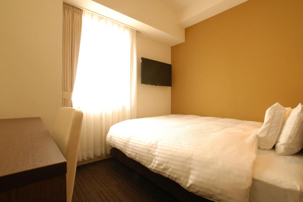 Postel nebo postele na pokoji v ubytování AB Hotel Fukaya