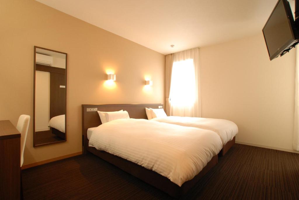 Postel nebo postele na pokoji v ubytování AB Hotel Fukaya