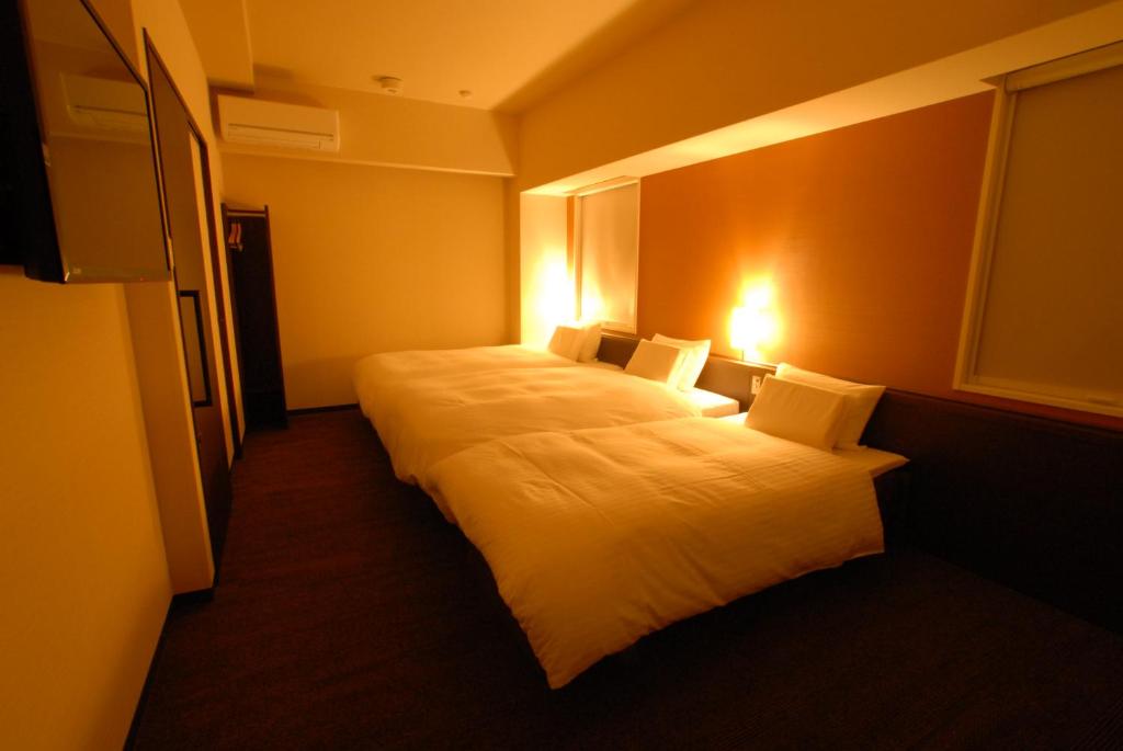 Postel nebo postele na pokoji v ubytování AB Hotel Nara